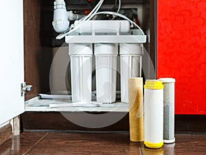 It`s time to change water filters at home.  Replace filters in water purifying system. Close up view  of three used filters.