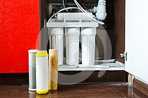 It`s time to change water filters at home. Replace filters in water purifying system. Close up view of three used filters