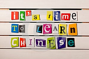 It's time to learn chinese - written with color magazine letter clippings on wooden board. Chinese language learning