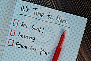 It`s Time to Start write on a book isolated on Wooden Table. Suported by additional service