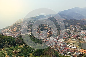 Sa Pa landscape with city, mountains, fog and trees the view from above from Sam Bay Cloud Yard in summer at Ham Rong Mountain.