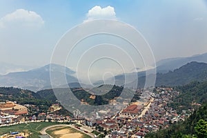 Sa Pa landscape with city, mountains, fog and trees the view from above from Sam Bay Cloud Yard in summer at Ham Rong Mountain.