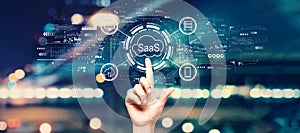 SaaS - software as a service concept with hand pressing a button