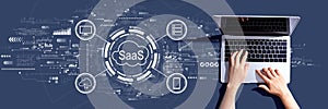 SaaS - software as a service concept with person using a laptop