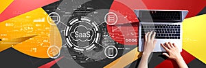 SaaS - software as a service concept with person using a laptop