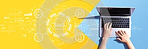 SaaS - software as a service concept with person using a laptop