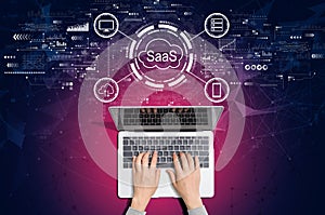 SaaS - software as a service concept with person using laptop