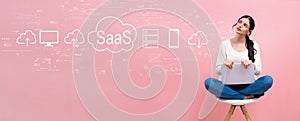 SaaS - software as a service concept with woman using a laptop