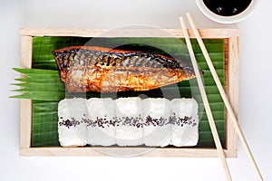 Saba grilled and sushi sprinkled with black sesame seeds on a wooden tray, Japanese food on white background