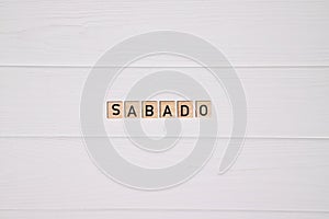Sabado week day name on white wooden background photo