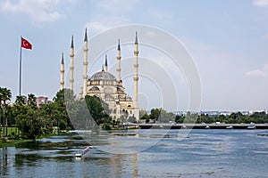 Sabanci Merkez Cami Central Mosque on the Seyhan River in cloudy weather in Turkey