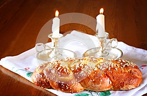Sabbath image. challah bread and candelas on wooden table