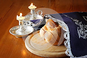 Sabbath image. challah bread and candelas on wooden table