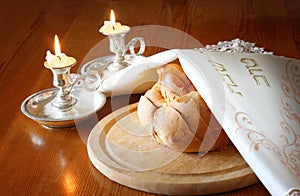 Sabbath image. challah bread and candelas on wooden table