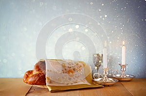 Sabbath image. challah bread and candelas on wooden table