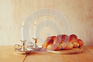 Sabbath image. challah bread and candelas on wooden table