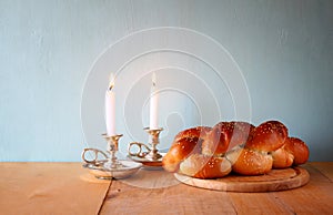 Sabbath image. challah bread and candelas on wooden table