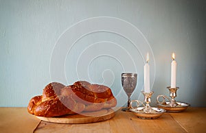 Sabbath image. challah bread and candelas on wooden table