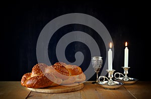 Sabbath image. challah bread and candelas on wooden table