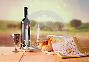 Sabbath image. challah bread and candelas on wooden table