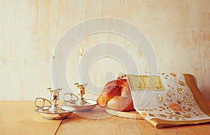 Sabbath image. challah bread and candelas on wooden table