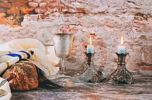 Sabbath Jewish Holiday challah bread and candelas on wooden table