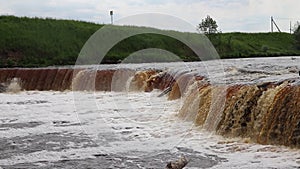 Sablinsky waterfalls. Little waterfall. The brown water of the waterfall. Thresholds on the river. Strong water flow. Jets of wate