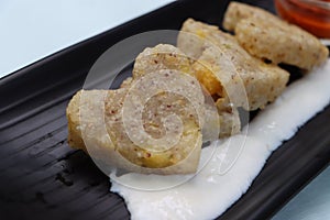 Sabudana vada or wada, sabu vada, traditional deep fried snack made with tapioca balls from Maharashtra, India, served with curd