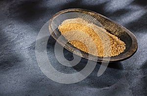 Saccharum officinarum - Organic brown sugar in the wooden bowl