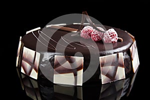 Sacher cake decorated with raspberries