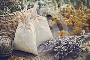 Sachets filled with dried herbs and bunches of healing herbs.