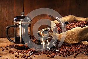 Sack of coffee beans with french press photo