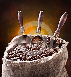 Sack of coffee beans and scoop.