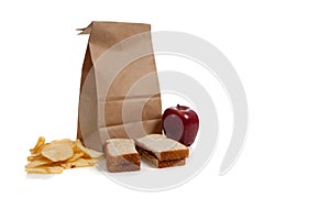A Sack lunch with peanut butter sandwich