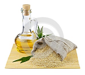 Sack of sesame seeds and glass bottle of oil