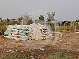 Sacks / bags of dairy co`s dry manure being stacked up, ready to be sold and used as organic fertilizer