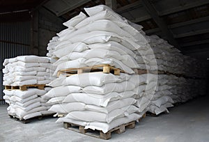 Sacks of flour and grain are stacked in neat rows in the farm\'s warehouse.