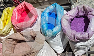 Sacks with paint pigment in different colors