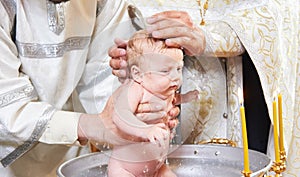 The sacrament of baptism. Newborn baby during christening