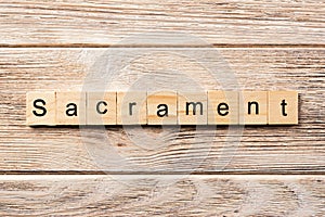 Sacrament word written on wood block. sacrament text on table, concept