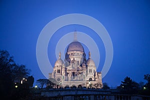 Sacre Coeur Basilica in Montmartre, Paris, illuminated during a winter night.