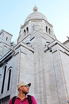 Sacre Coeur Cathedral in Montmartre, Paris, France, young man on an early morning in Paris