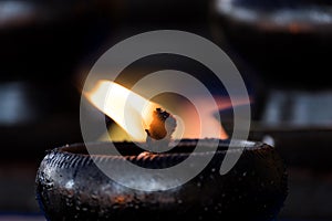 Sacred fire, coconut oil lamps in a buddhist temple