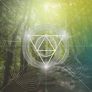 Sacred geometry symbol on blurred photo background. Mathematics and spirituality in nature.