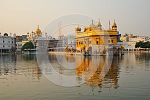 The Golden Temple in evening sun reflected in the lake in Amristar, India photo