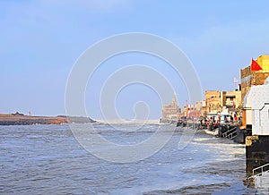Sacred Gomti River meeting the Ocean, Indian Traditional Ghats and Hindu Temple at Distance - Devbhoomi Dwarka, Gujarat, India