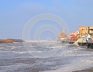 Sacred Gomti River meeting the Ocean, Indian Traditional Ghats and Hindu Temple at Distance - Devbhoomi Dwarka, Gujarat, India