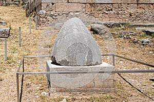 The Sacred Omphalos Stone, the center of the world in the archaeological site of Delphi in Fokida, Greece.