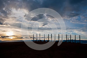 A sacred place of power with pillars and ribbons at Cape Burhan of Olkhon Island at sunset