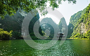 Sacred temple on the lake, sorrounded by mountain at Trang An